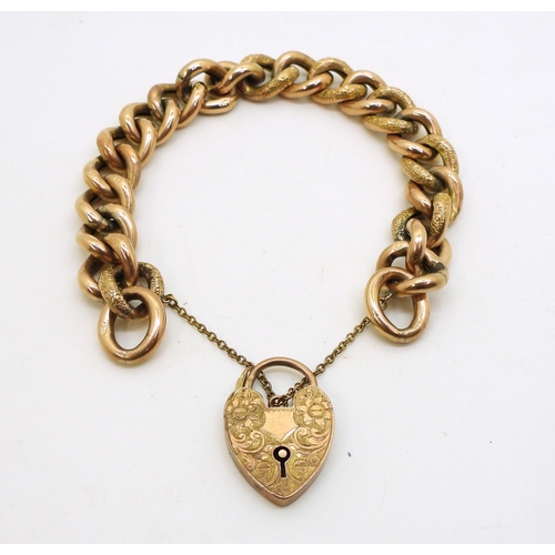 2843 - A 9CT CURB CHAIN BRACELETwith flower engraved heart shaped clasp, and with engraved texture  to ever... 