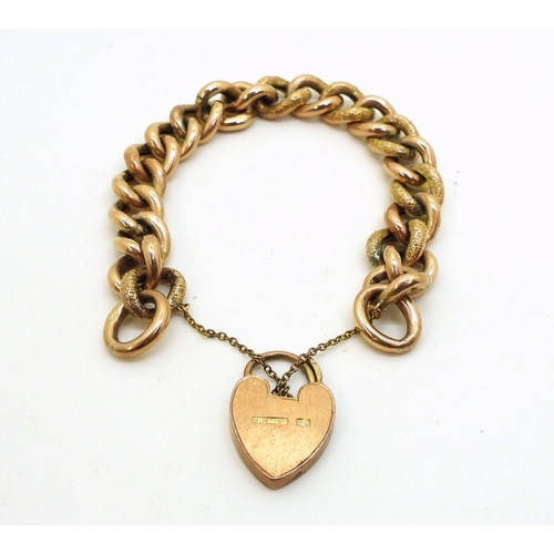 2843 - A 9CT CURB CHAIN BRACELETwith flower engraved heart shaped clasp, and with engraved texture  to ever... 