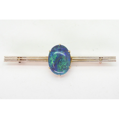 2845 - AN OPAL BROOCH BY WENDTSset in 15ct gold, the blue green oval opal with the dimensions of 14.5mm x 1... 