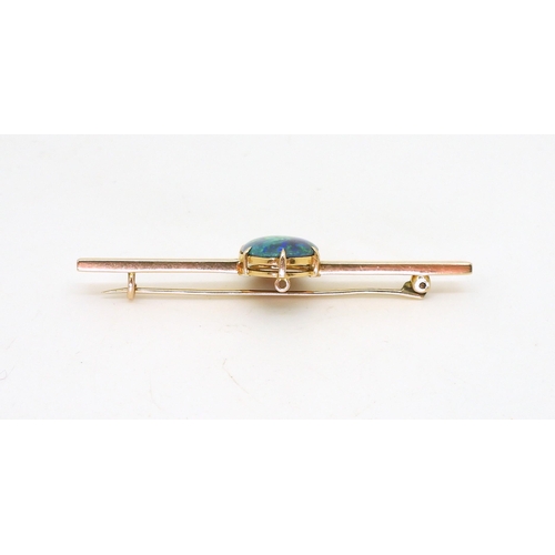 2845 - AN OPAL BROOCH BY WENDTSset in 15ct gold, the blue green oval opal with the dimensions of 14.5mm x 1... 