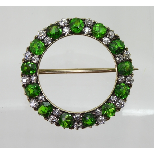 2856 - A DEMANTOID GARNET BROOCHthe thirteen demantoid garnets are each approx 3.8mm x 3.5mm x 2.5cm, inter... 