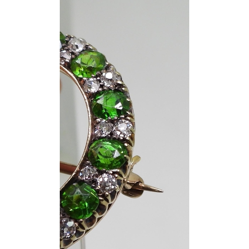 2856 - A DEMANTOID GARNET BROOCHthe thirteen demantoid garnets are each approx 3.8mm x 3.5mm x 2.5cm, inter... 