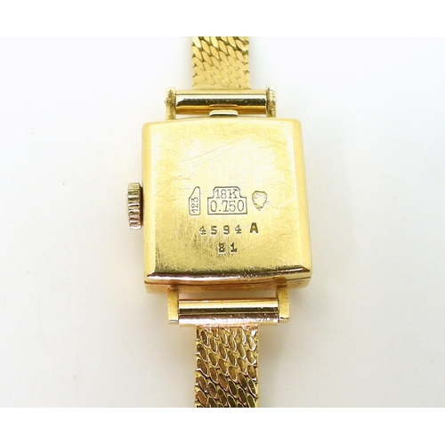 2919 - A LADIES CONSUL WATCHmade in 18ct gold with mesh strap stamped 750. the case is 1.6cm, the strap len... 