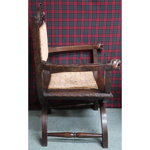 11 - A Victorian oak Gothic revival hall armchair with upholstered splat carved with green man masque ove... 