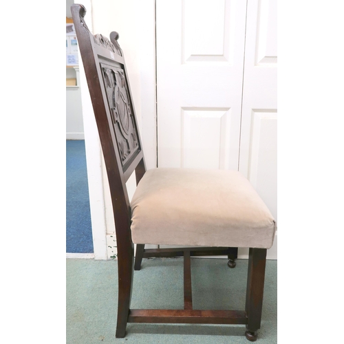 21 - A 19th century oak hall chair with solid panel splat carved with shield over upholstered seat on car... 