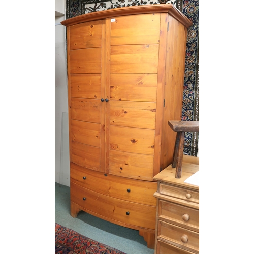 28 - A pair of contemporary pine HP bow front armoires (one def) with pair of doors over two long drawers... 