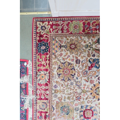 40 - A cream ground James Templeton & Co Ltd carpet with all over floral patterned ground and red flo... 