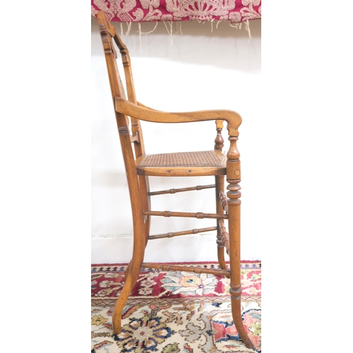 42 - A Victorian walnut framed bergere children's high chair with shaped splat inlaid with game bird over... 