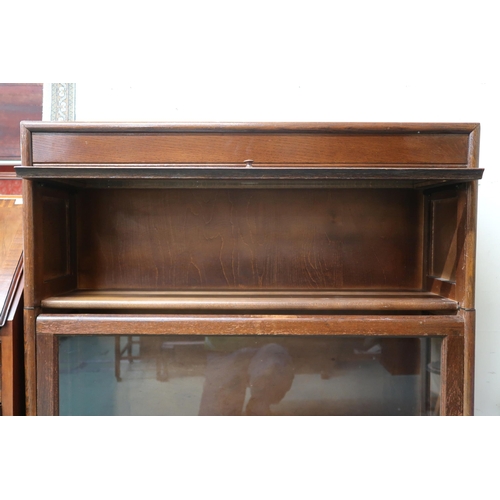 48 - A 20th century oak Gunn three tier sectional bookcase with each section with glazed lift door, 117cm... 