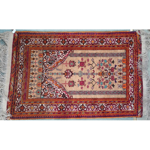 68 - A beige ground Persian prayer mat/rug with floral geometric patterned ground and multicoloured borde... 