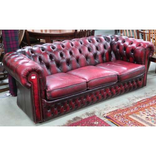 73 - A 20th century oxblood leather buttonback upholstered Chesterfield style three seater sofa, 68cm hig... 