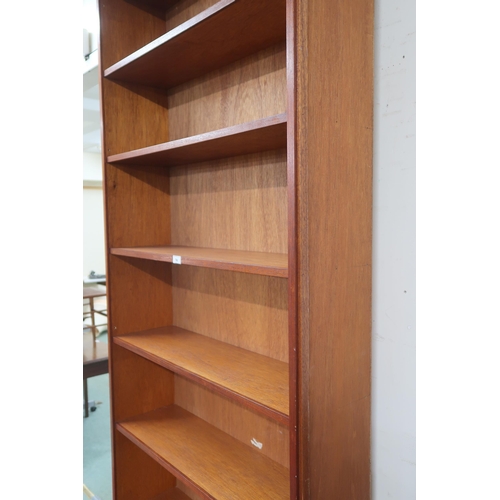 74 - A large 20th century teak open bookcase with seven fixed shelves, 244cm high x 89cm wide x 26cm deep... 