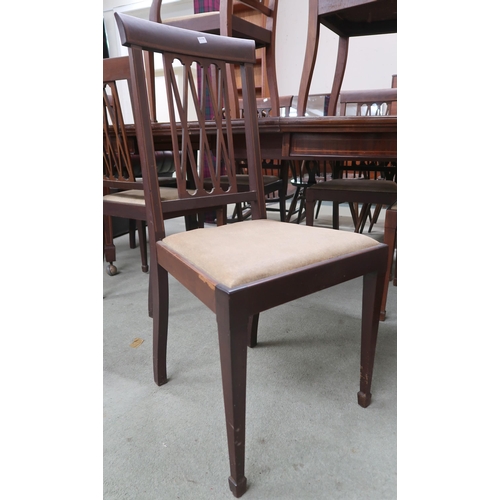 82 - A late Victorian mahogany dining suite comprising oval wind out extending dining table on square tap... 