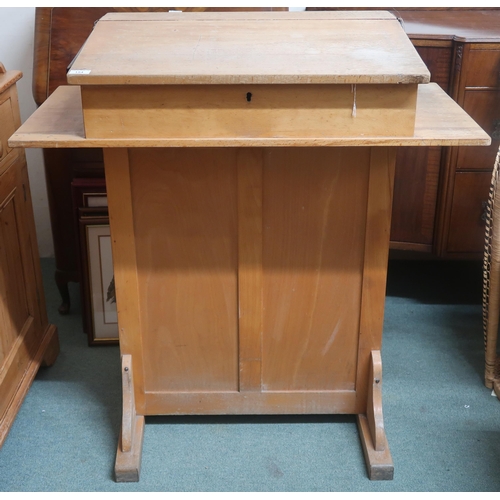 92 - An early 20th century white oak school teachers desk with hinged top writing slope over single cabin... 