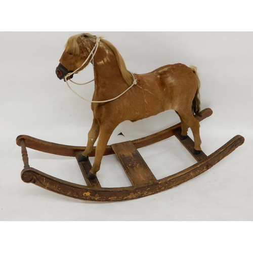 93 - A 19th century children's rocking horse, hide covered main body with horse hair main and tail on elm... 