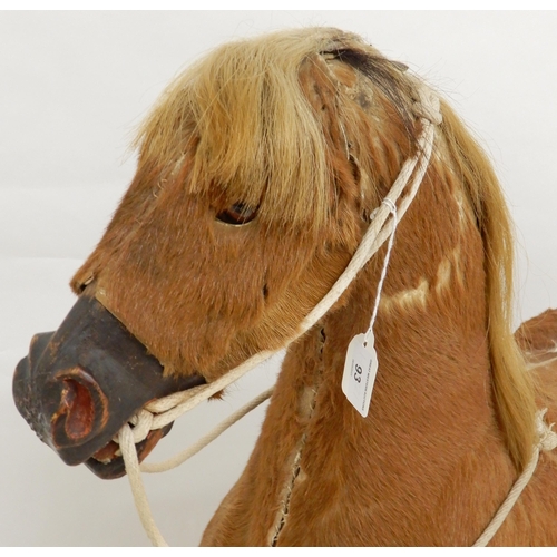 93 - A 19th century children's rocking horse, hide covered main body with horse hair main and tail on elm... 