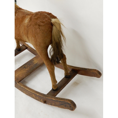 93 - A 19th century children's rocking horse, hide covered main body with horse hair main and tail on elm... 