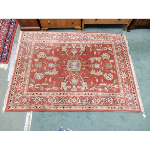 94 - A pair of terracotta ground Kazak style rug with all over geometric patterned ground with multicolou... 