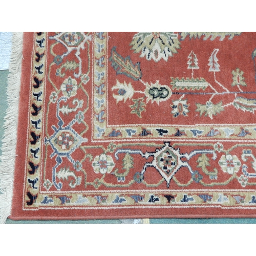 94 - A pair of terracotta ground Kazak style rug with all over geometric patterned ground with multicolou... 