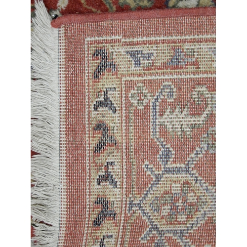 94 - A pair of terracotta ground Kazak style rug with all over geometric patterned ground with multicolou... 