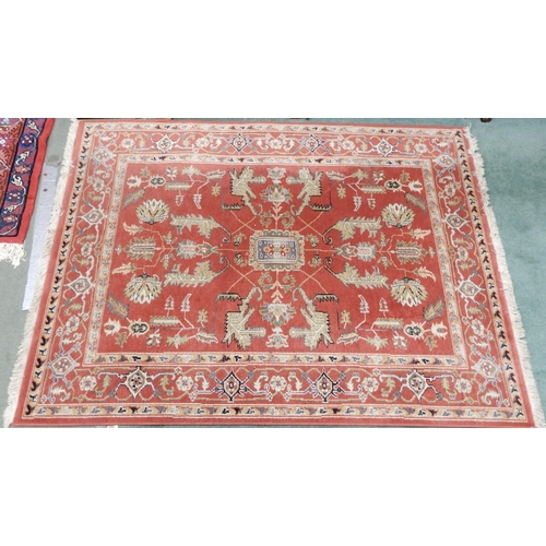 94 - A pair of terracotta ground Kazak style rug with all over geometric patterned ground with multicolou... 