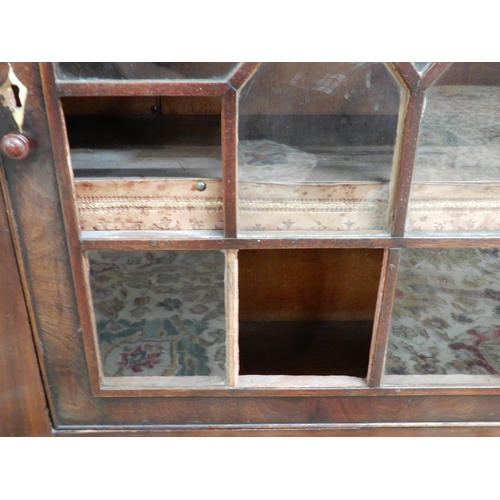 95 - A Victorian mahogany astragal glazed pier cabinet with single door concealing two shelves with embos... 