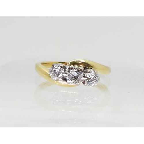 719 - An 18ct gold three stone on a twist, set with estimated approx 0.40cts of brilliant cut diamonds, fi... 