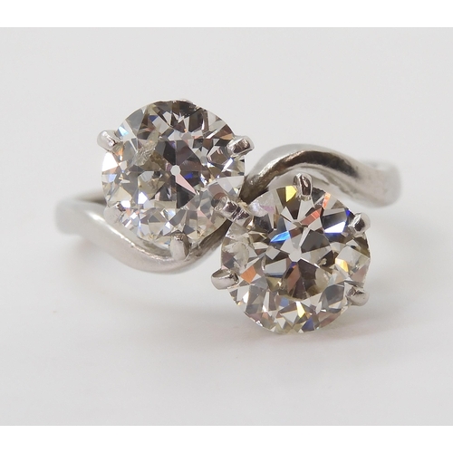 732 - A substantial twin stone diamond ring, set with two old cut diamonds with an estimated approx diamon... 