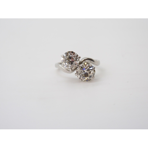 732 - A substantial twin stone diamond ring, set with two old cut diamonds with an estimated approx diamon... 