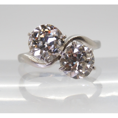 732 - A substantial twin stone diamond ring, set with two old cut diamonds with an estimated approx diamon... 