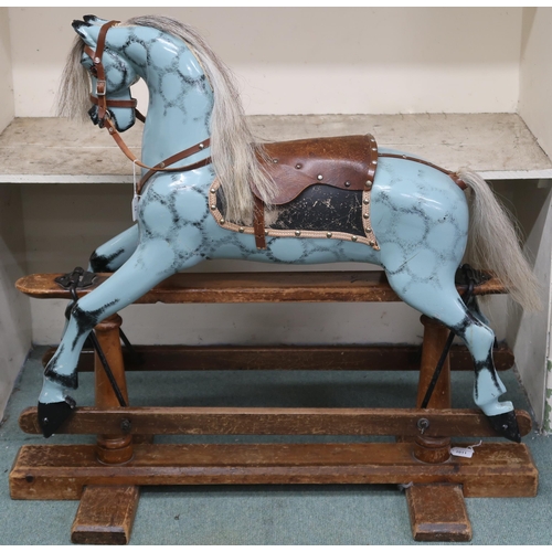 12 - An early 20th century child's rocking horse with horse hair mane and tail, leather reigns and saddle... 