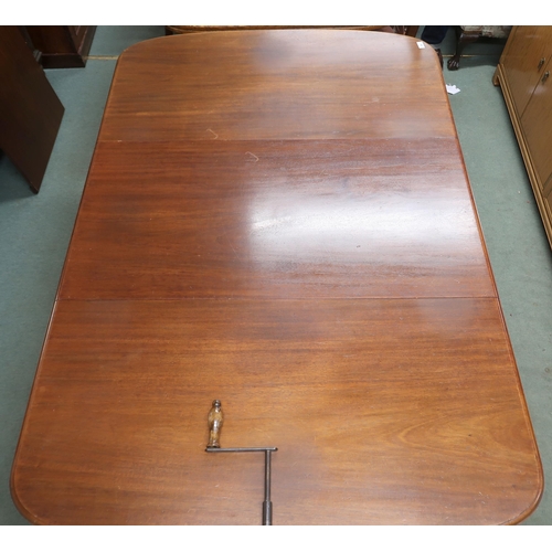 26 - A Victorian mahogany wind out extending dining table on square tapering supports terminating in cast... 