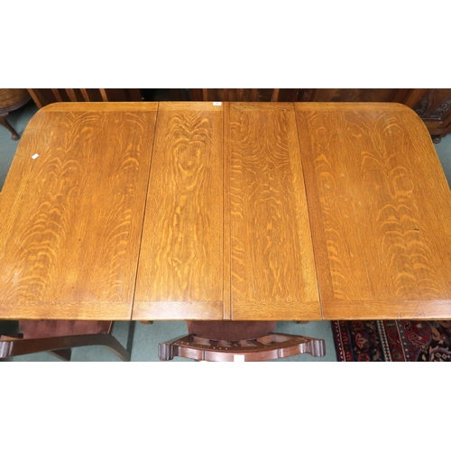 32 - A 20th century oak extending dining table with two internal leaves on pair of trestle supports joine... 