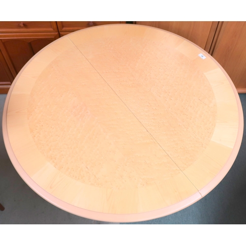 54 - A contemporary teak and birdseye maple drop side circular topped table, 74cm high x 110cm diameter