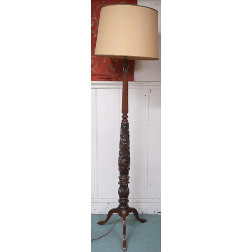 6 - A 20th century standard lamp carved with spiralling acanthus leaves on tripod base, 189cm high