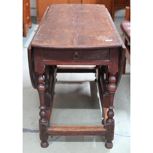 67 - An 18th century oak drop leaf table with oval drop end top over drawers to either end on turned supp... 