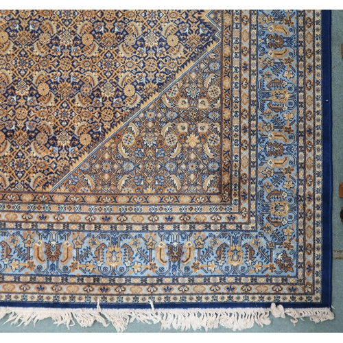 22 - A blue and beige patterned ground Prado Orient Keshan super rug with diamond central medallion, matc... 