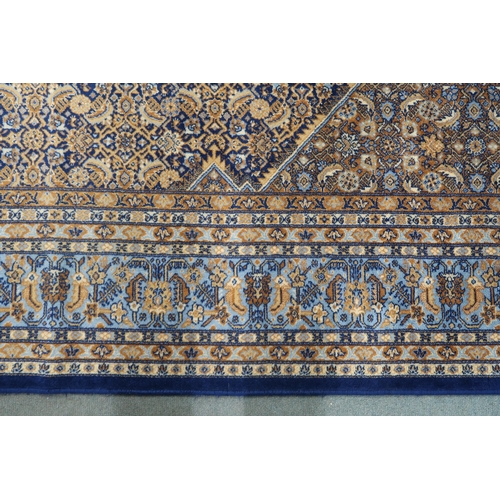 22 - A blue and beige patterned ground Prado Orient Keshan super rug with diamond central medallion, matc... 