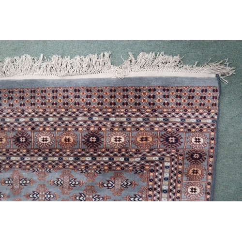 49 - A light blue ground Bokhara rug with all-over patterned ground with multicoloured border, 390cm long... 