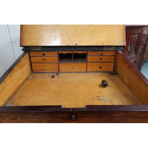 16 - A Victorian rosewood Davenport writing desk with hinged writing slope top over four drawers to right... 