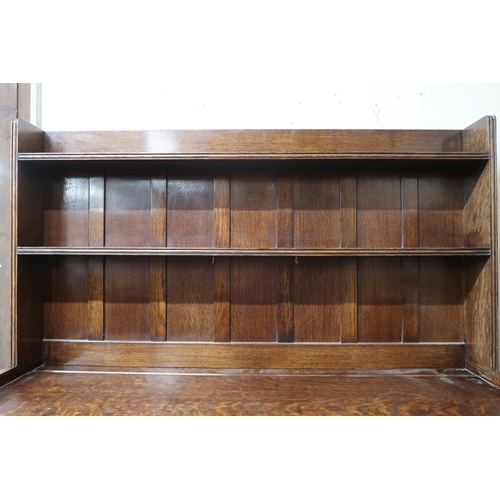 24 - A 20th century oak Wylie & Lochhead kitchen dresser with two tier plate rack over pair of drawer... 