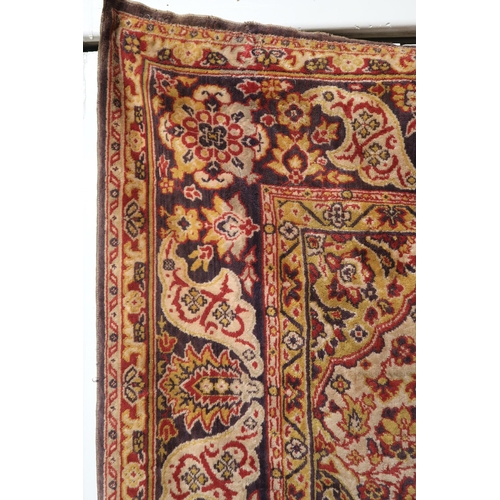 30 - A red ground Tabriz style wall tapestry with multicoloured central medallion, beige spandrels and mu... 