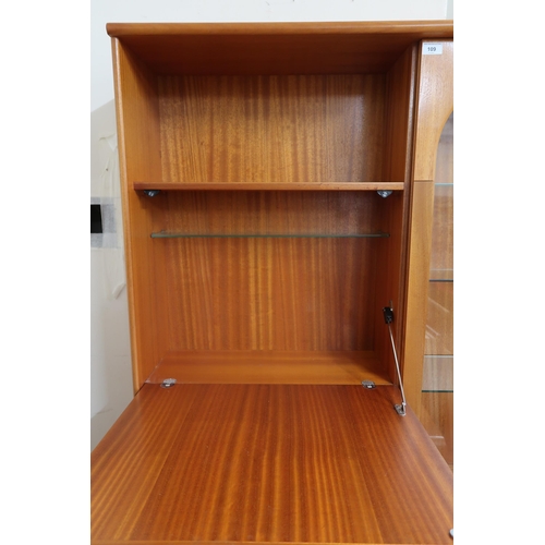 61 - A 20th century teak veneered wall unit with fall front compartment alongside glazed door on two door... 