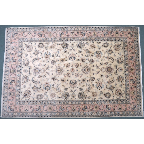 2132 - A CREAM GROUND FINE KASHAN RUG with all-over floral patterned ground and light pink flower head bord... 