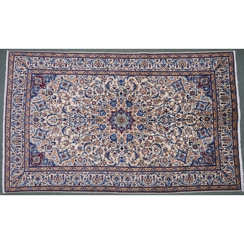 2134 - A CREAM GROUND NAIN RUG with a blue and red central medallion, matching spandrels on all-over floral... 