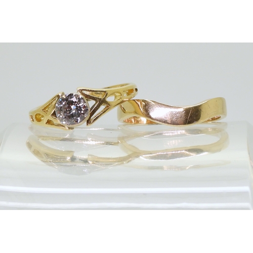 706 - An 18ct gold Celtic design ring set. The engagement ring is set with an estimated approx 0.60ct soli... 