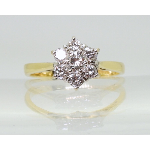 707 - An 18ct gold diamond flower ring, set with estimated approx 0.75cts of brilliant cut diamonds, finge... 