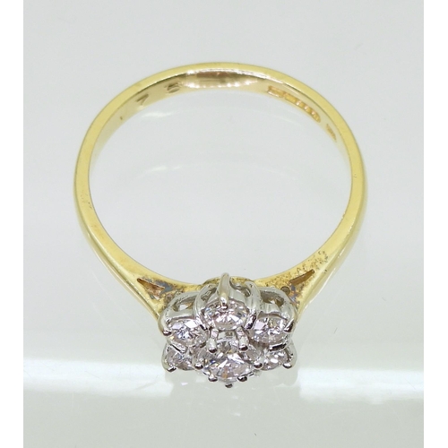 707 - An 18ct gold diamond flower ring, set with estimated approx 0.75cts of brilliant cut diamonds, finge... 