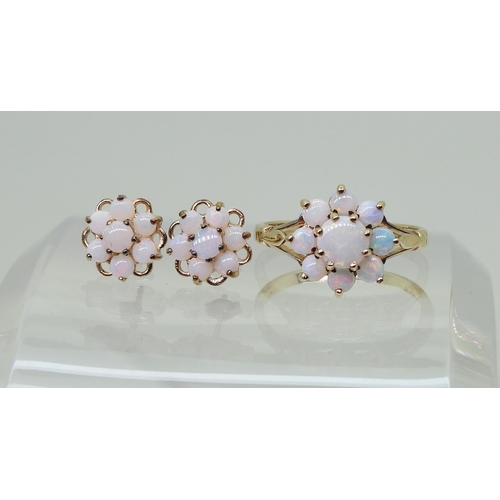 717 - A 9ct gold opal flower ring with matching earrings. Finger size J, weight with the earrings 2.8gms