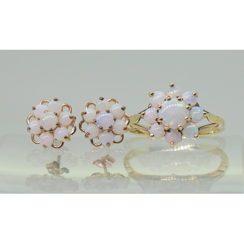 717 - A 9ct gold opal flower ring with matching earrings. Finger size J, weight with the earrings 2.8gms